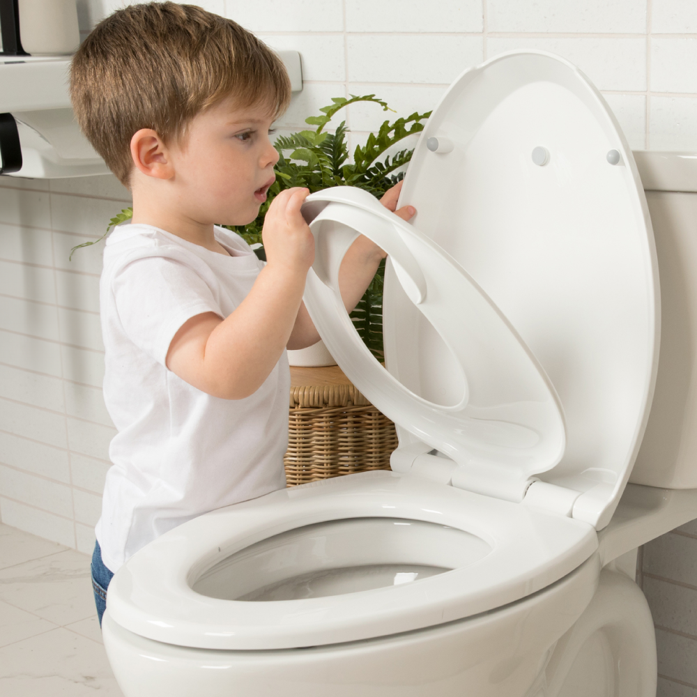 Toddler using quick flip potty seat for potty training