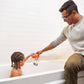 Man and child playing with a toy in a bathtub