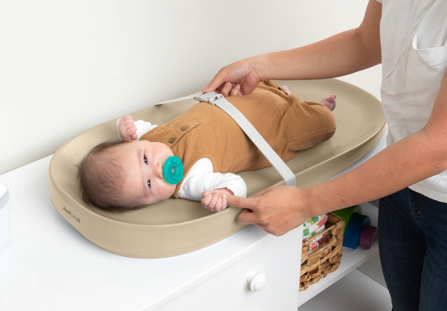 Mom changing baby on the waterproof premium changing pad in oatmeal.