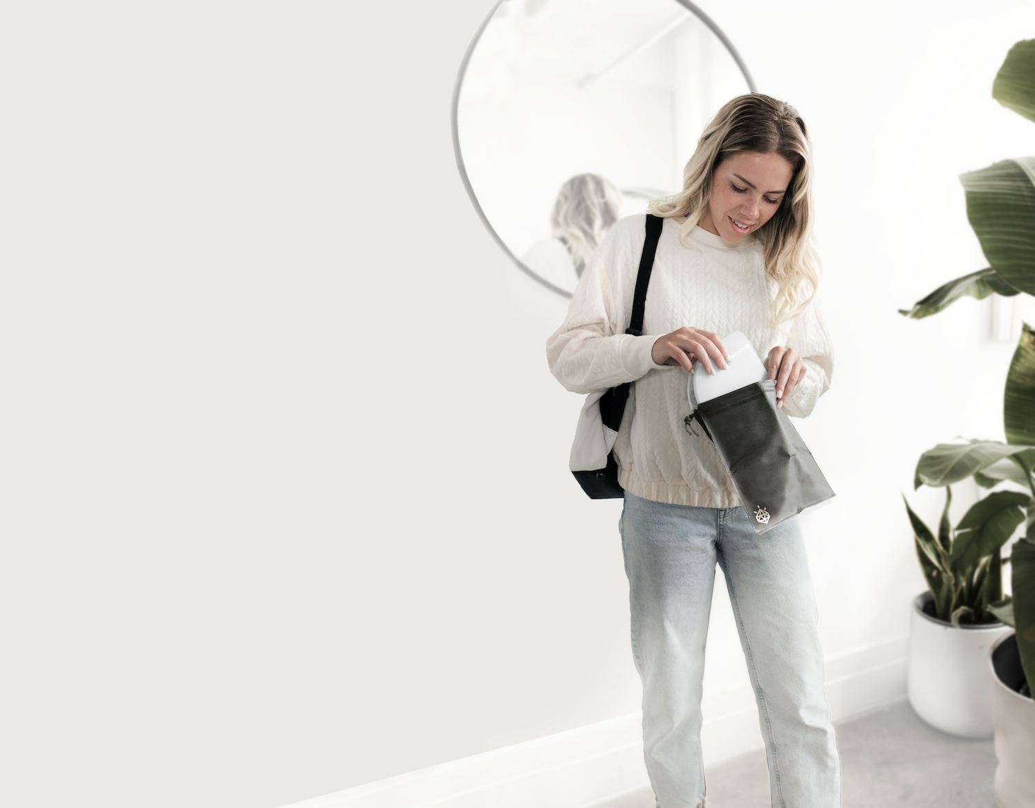 Mom packing her folding travel potty seat in diaper bag