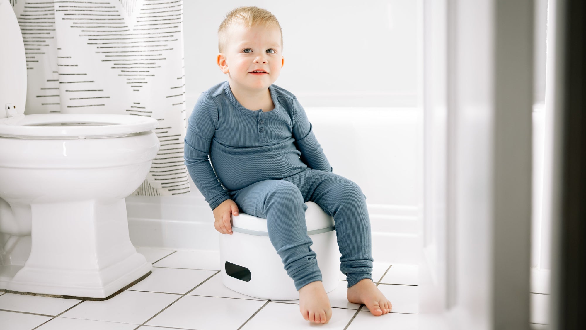 Child sitting on a potty in a bathroom