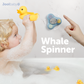 Child in bathtub. playing with rubber ducks and whale spinner