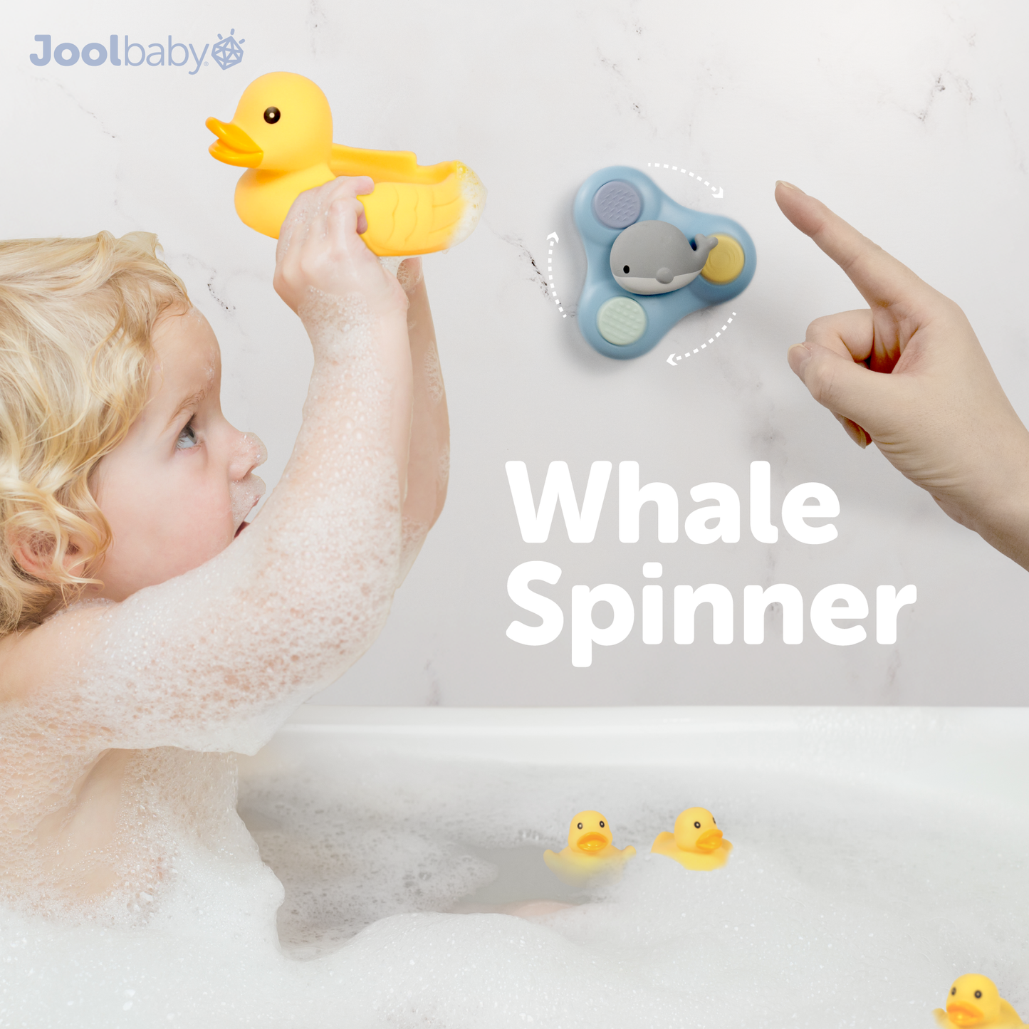 Child in bathtub. playing with rubber ducks and whale spinner