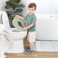 Child interacting with a toilet seat cover in a bathroom setting