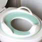 The handled potty seat on a toilet