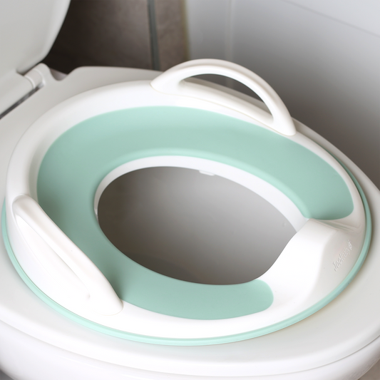 The handled potty seat on a toilet