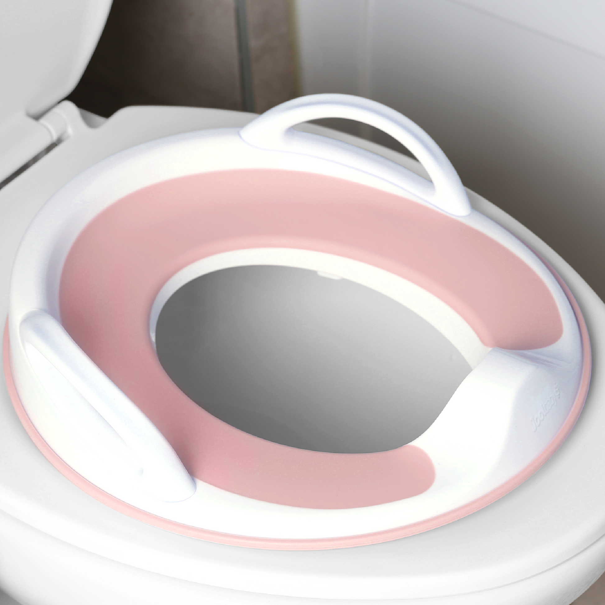 Jool Baby potty training seat with handles in pink on toilet