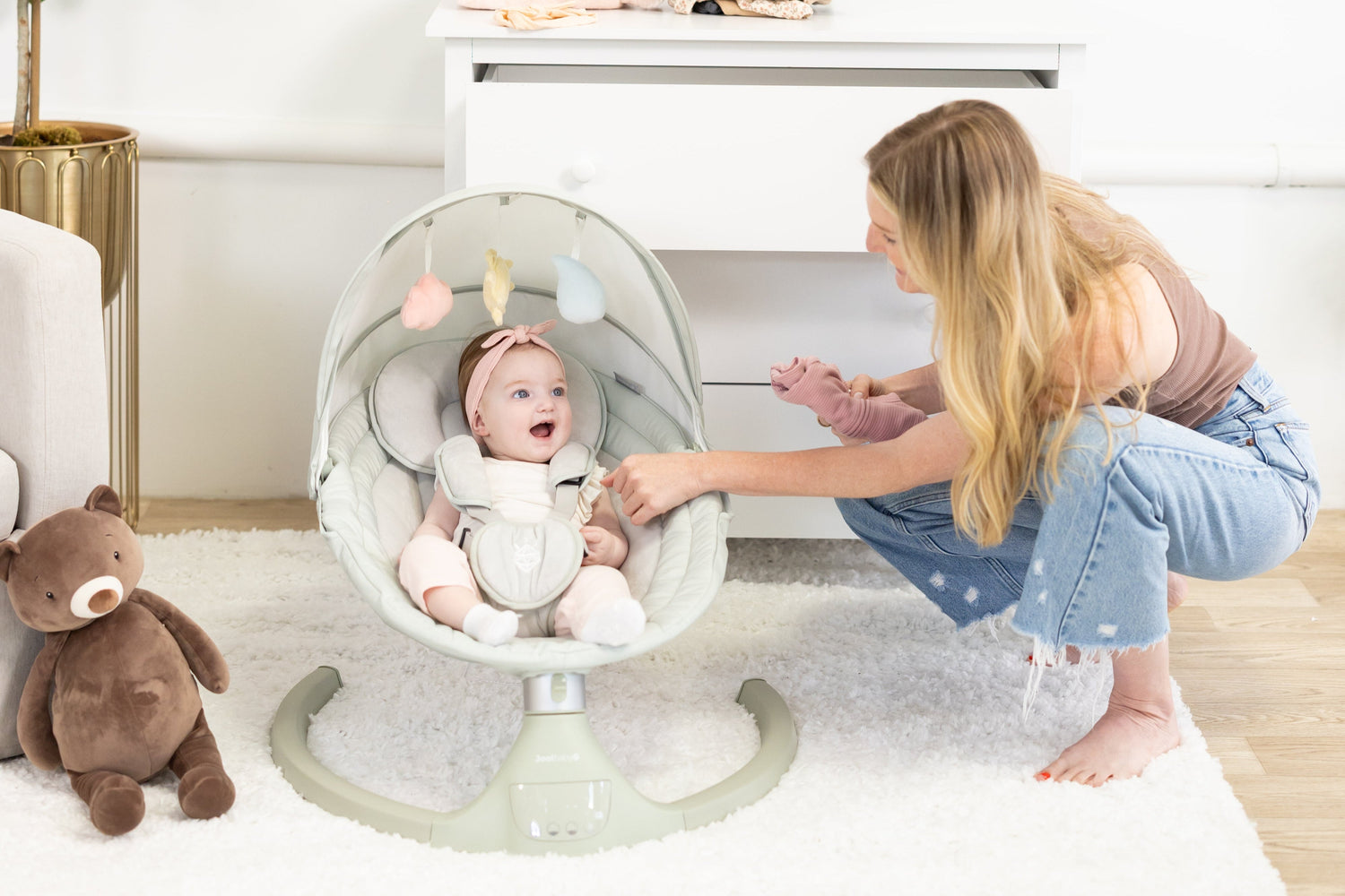 Mom in nursery with baby in Nova Signature Swing