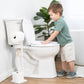 Child interacting with a toilet in a bathroom setting