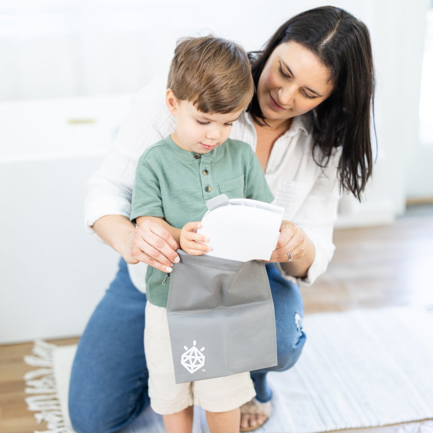 Woman and child with folding travel potty seat and travel bag