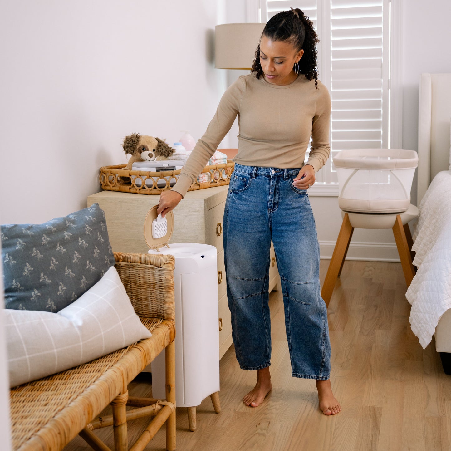 Mom in nursery with diaper pail
