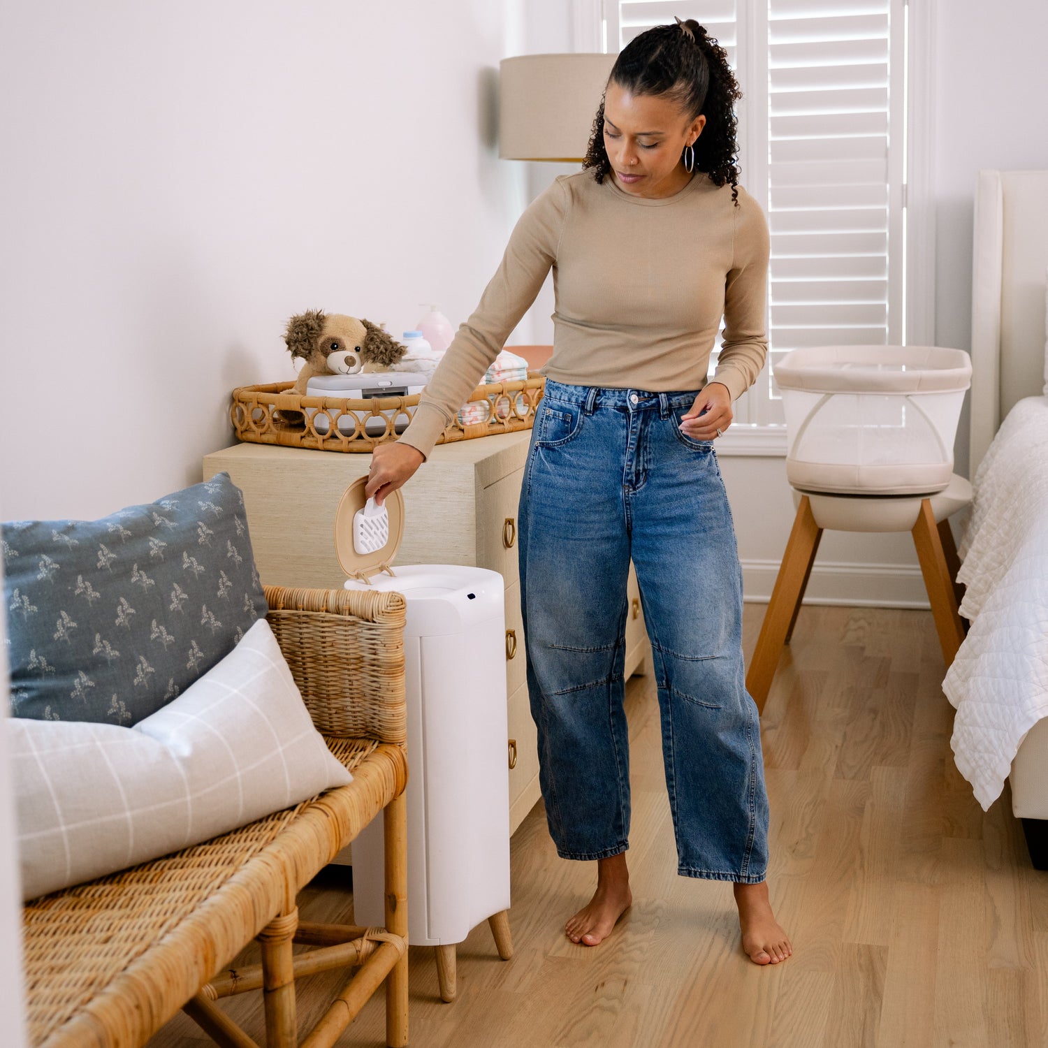Mom in nursery with diaper pail